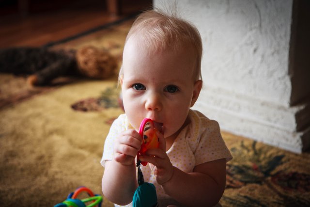 Sonja eating her toys